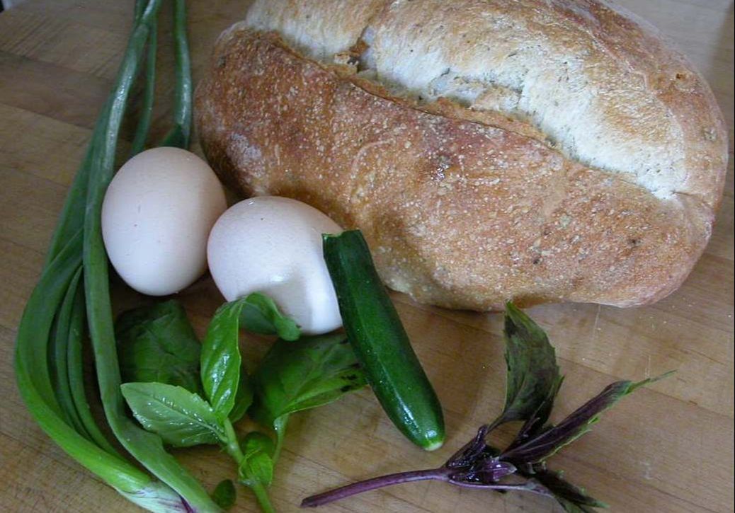Fresh loaf with eggs, basil and zucchini